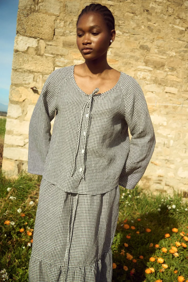 Black gingham linen top with tie neckline and relaxed fit, paired with a matching skirt