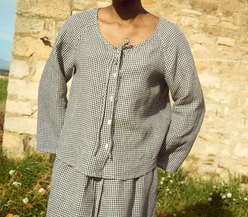 Black gingham linen top with tie neckline and relaxed fit, paired with a matching skirt