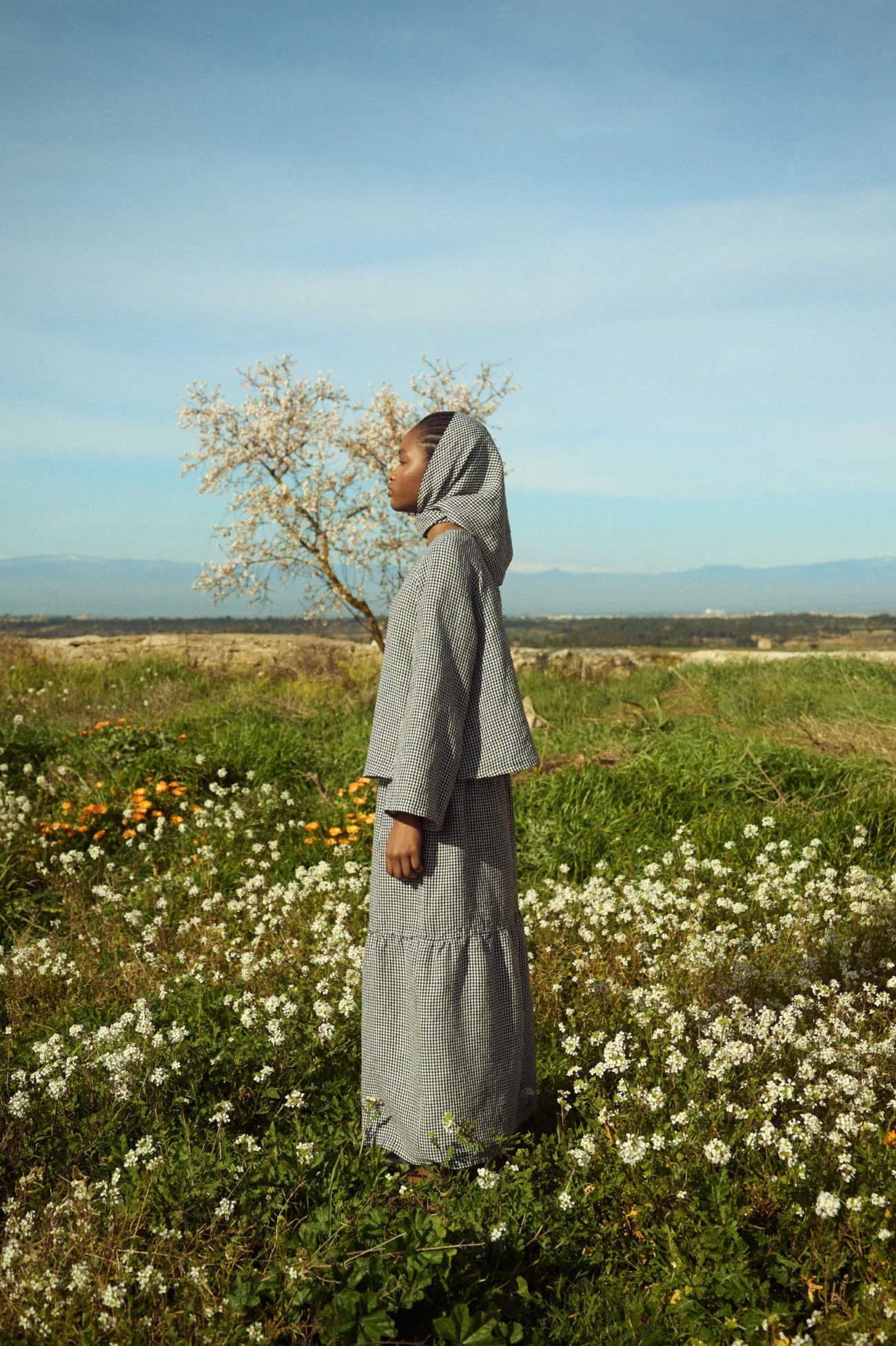 Lightweight black gingham linen maxi skirt with elasticated waist and tiered hem, worn with a matching headscarf and linen blouse
