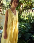 Butter yellow linen sleeveless midi dress with lace-trim V-neck, armholes, and hem, and a gently gathered waist