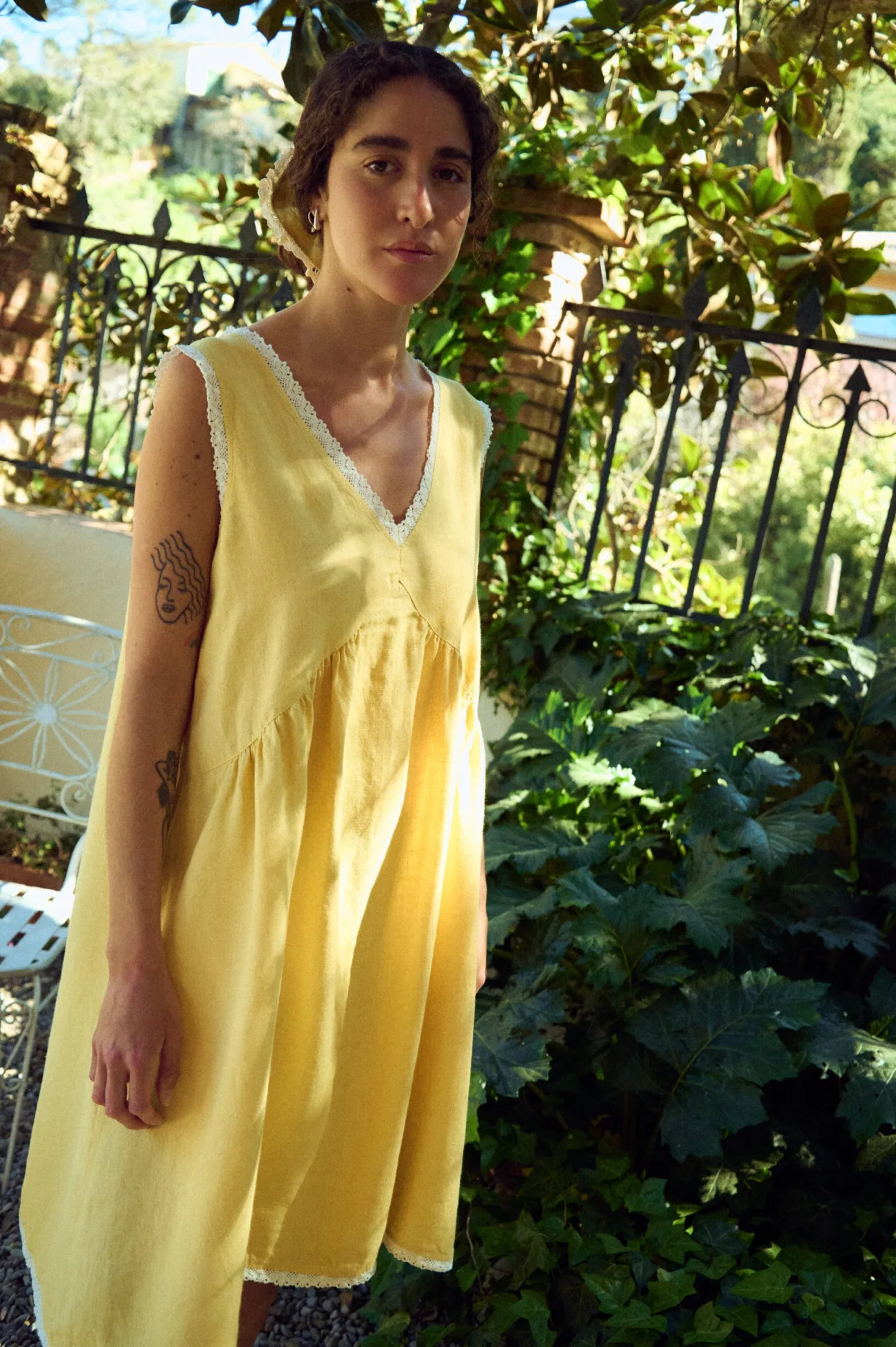 Butter yellow linen sleeveless midi dress with lace-trim V-neck, armholes, and hem, and a gently gathered waist
