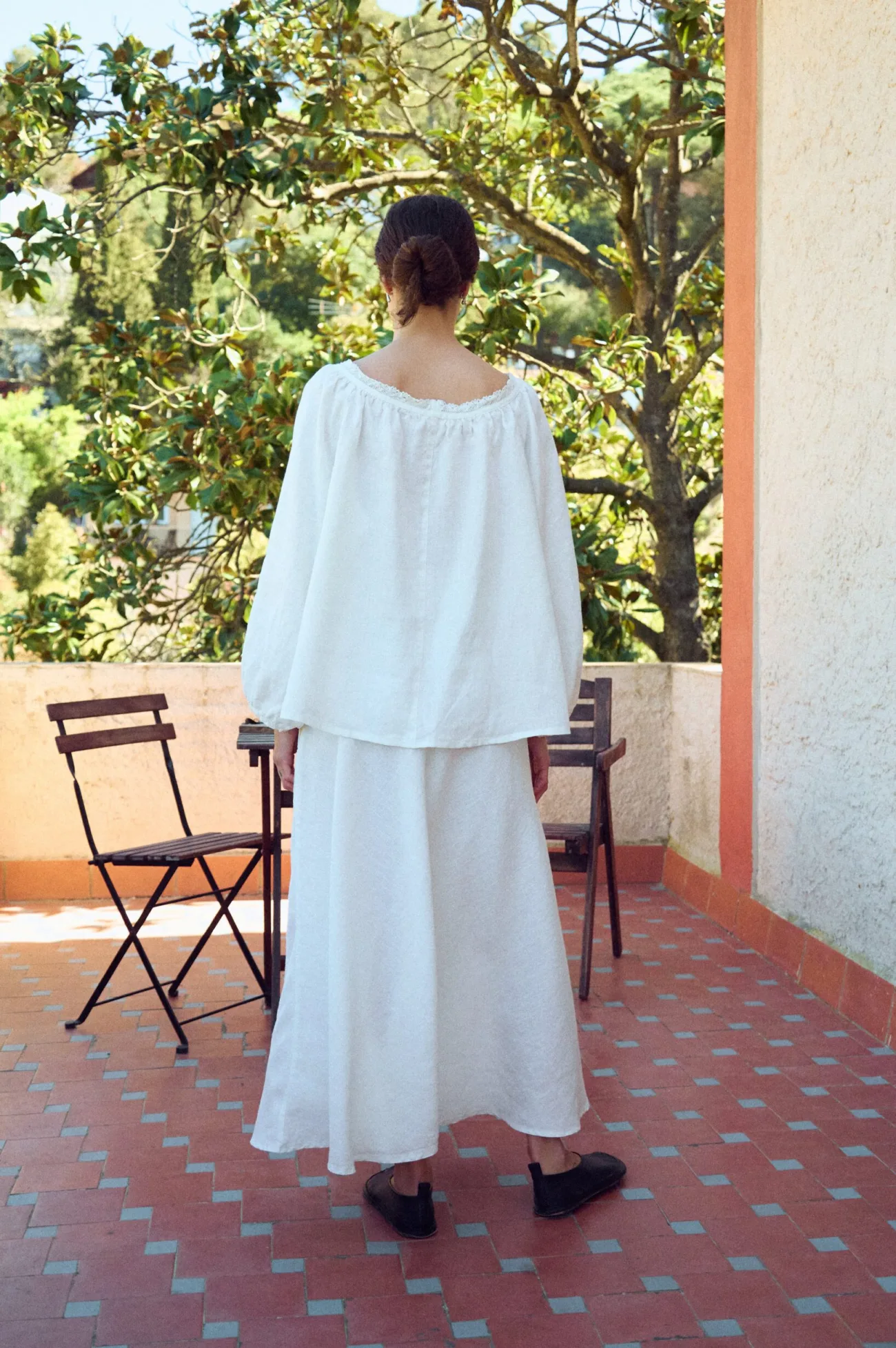 back view of maxi white linen skirt in bias cut paired with oversized linen blouse
