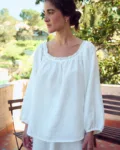 woman is wearing oversized linen tunic in white linen