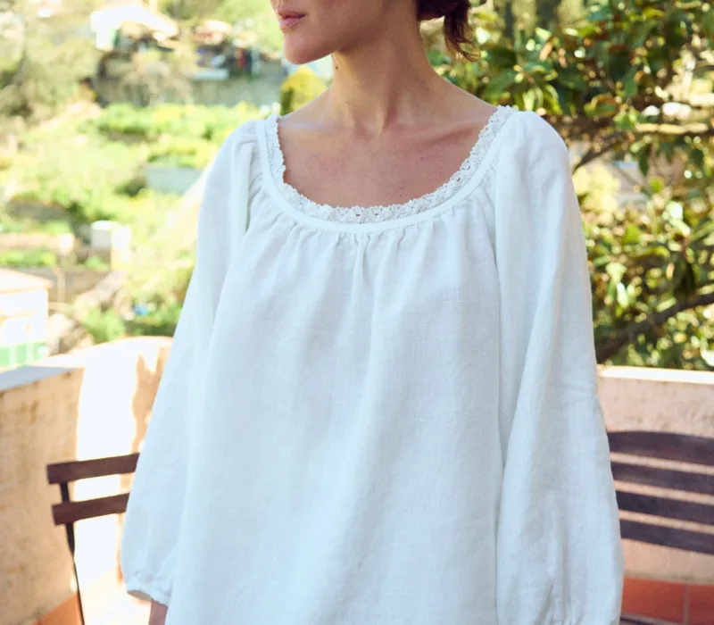 woman is wearing oversized linen tunic in white linen