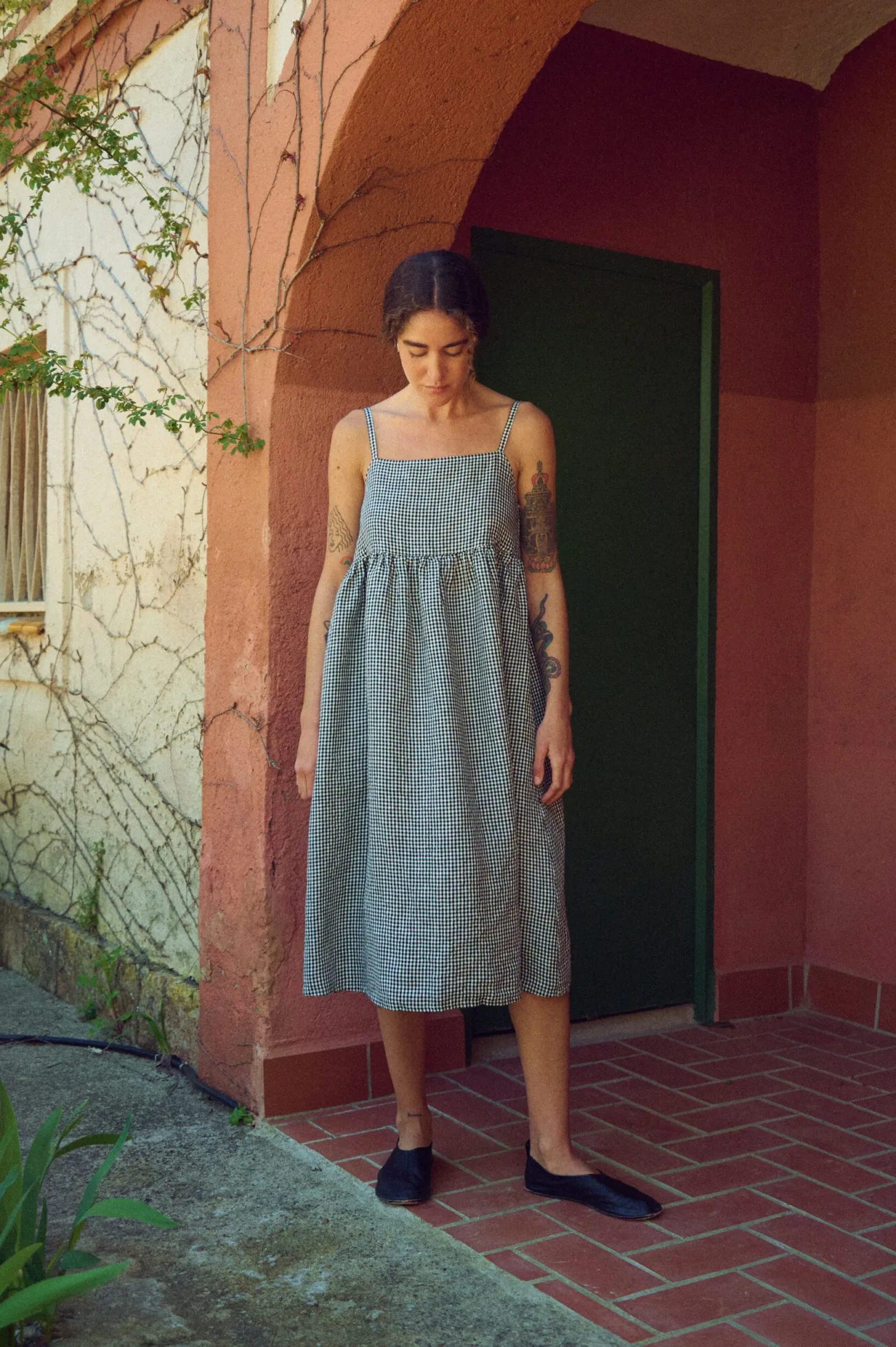 woman wearing black gingham linen summer midi dress with straps