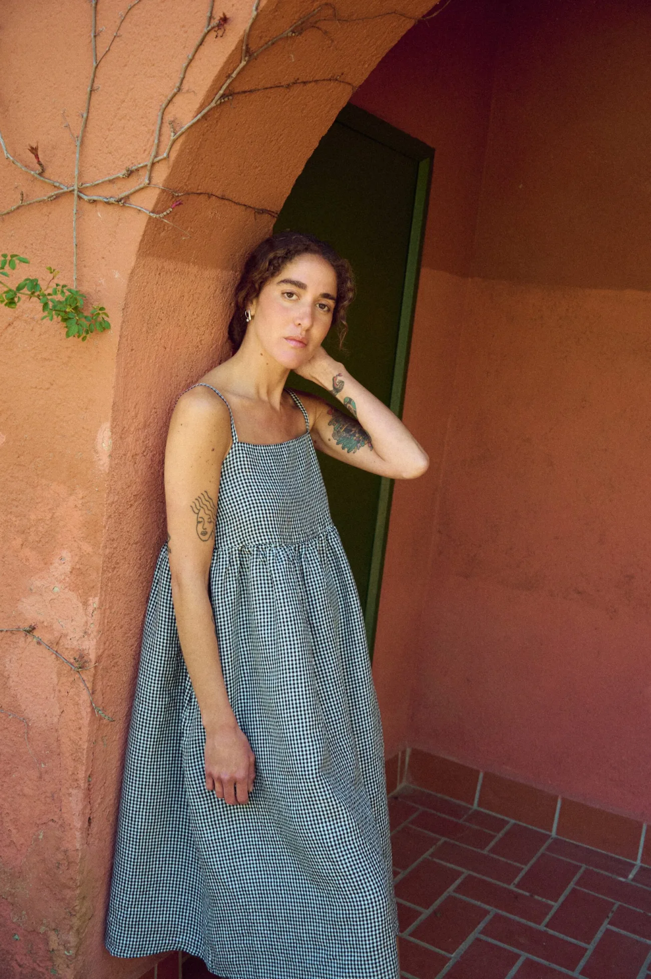 woman wearing summer black gingham linen dress in midi length
