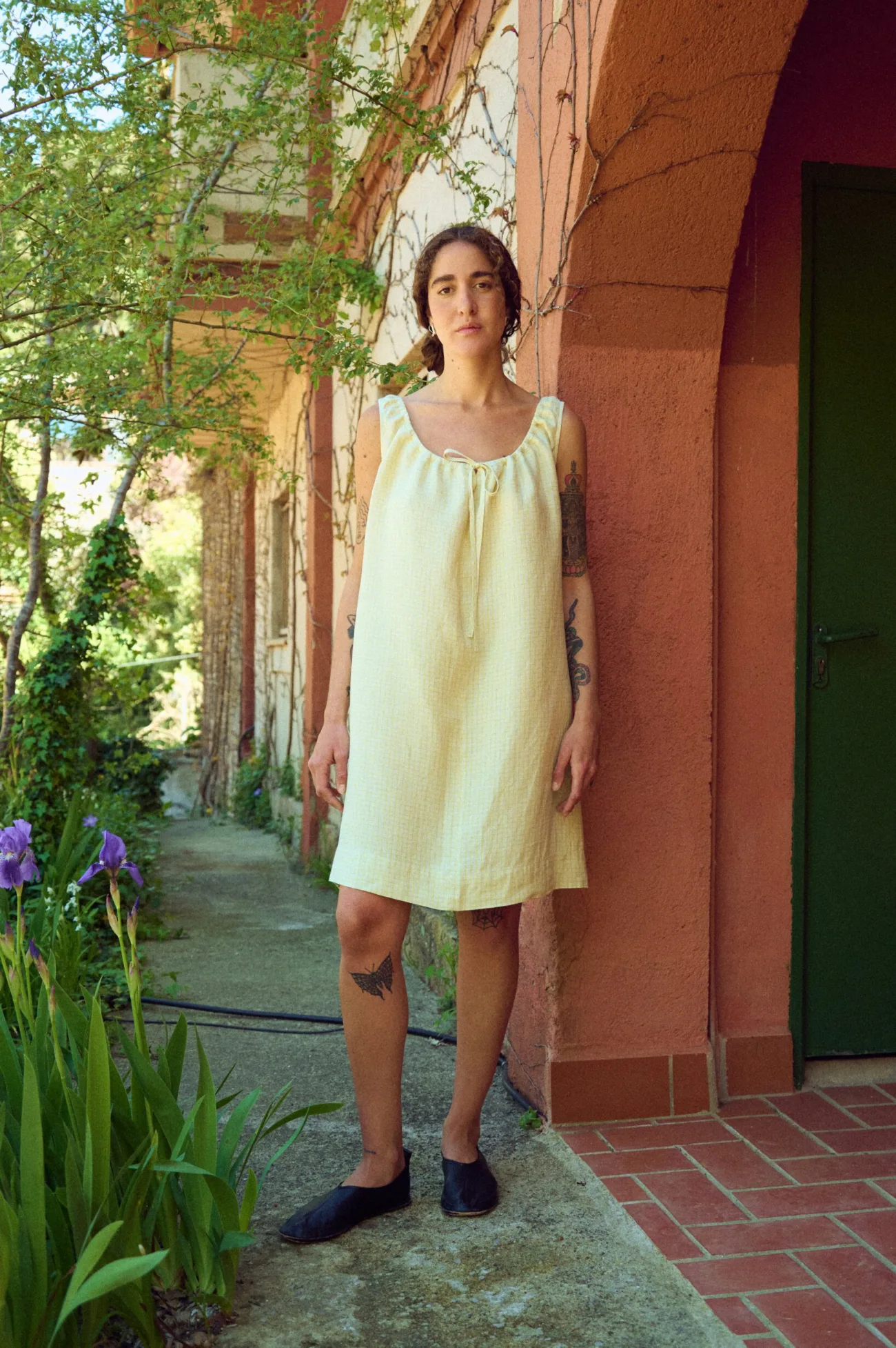 woman wearing checked linen dress with drawstring neckline in mini length