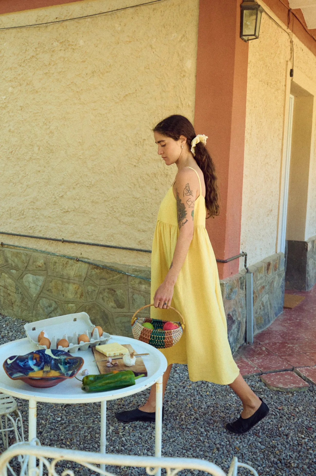 woman wearing butter yellow strap linen dress in midi length