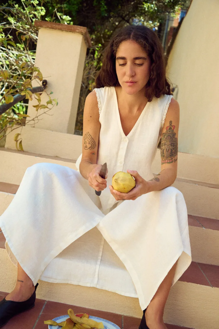 women is wearing button down maxi dress in white linen