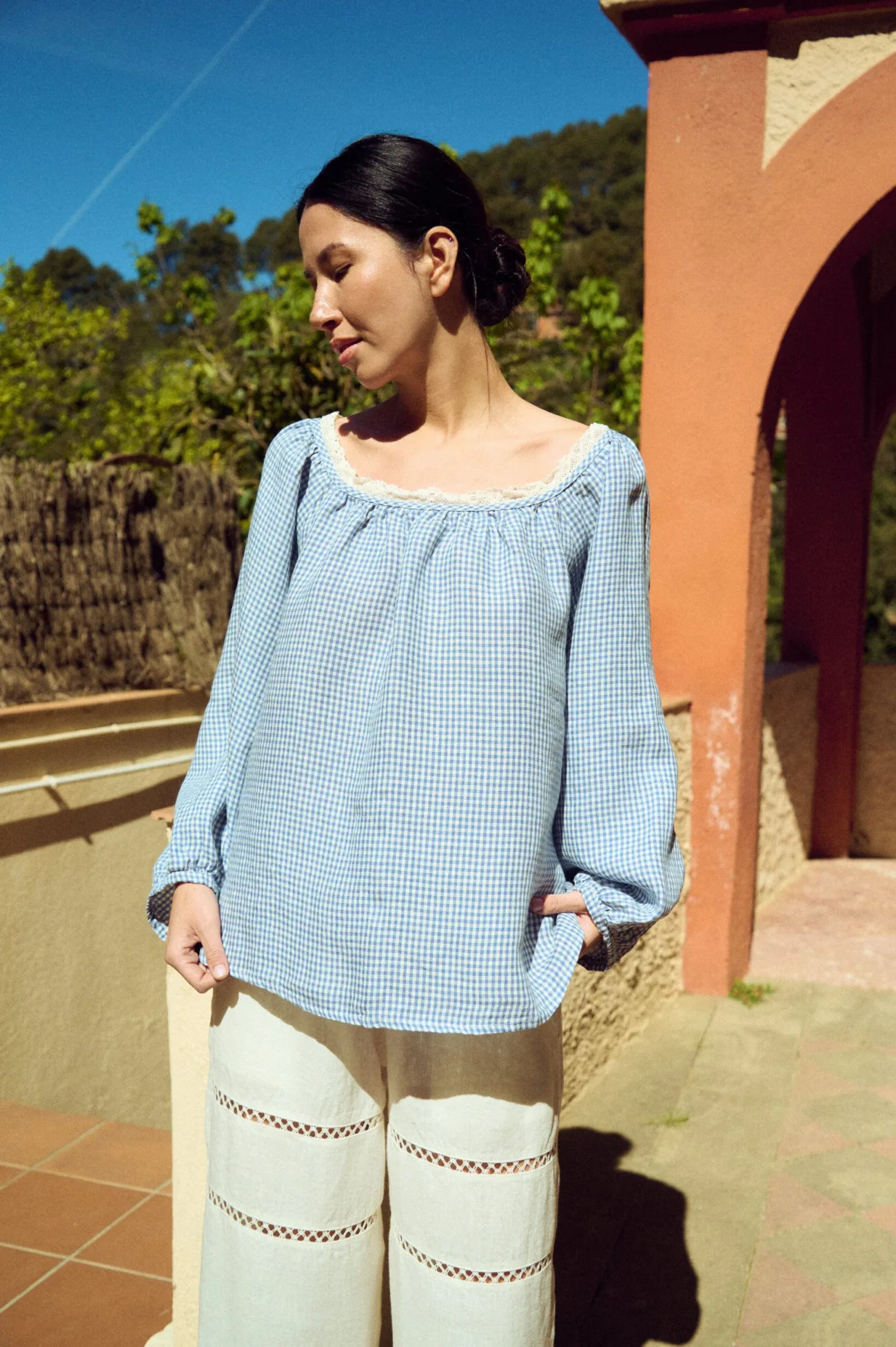 front view of oversized blue gingham linen blouse with lace neckline