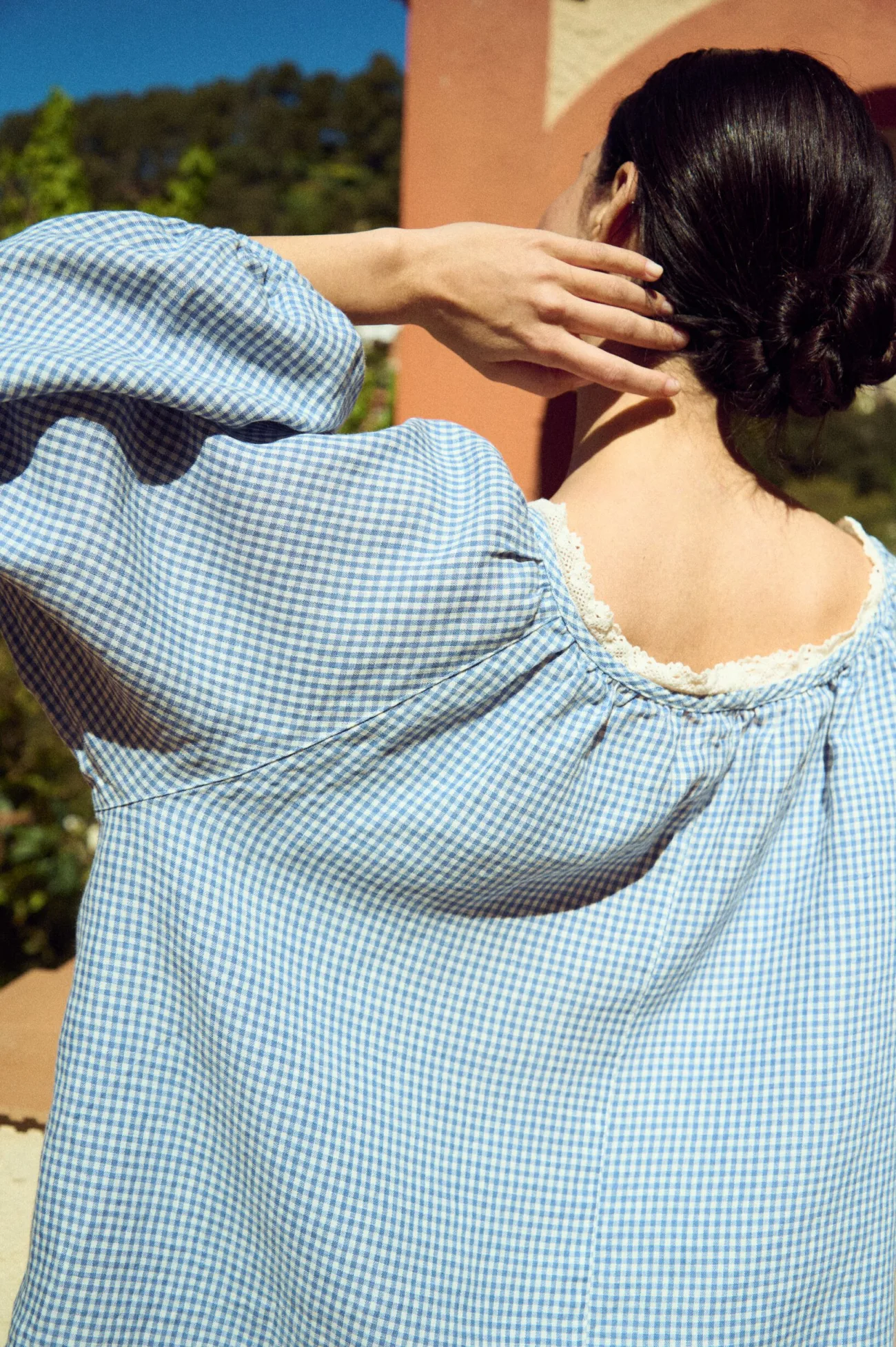 close-up of blue gingham linen blouse with lace neckline