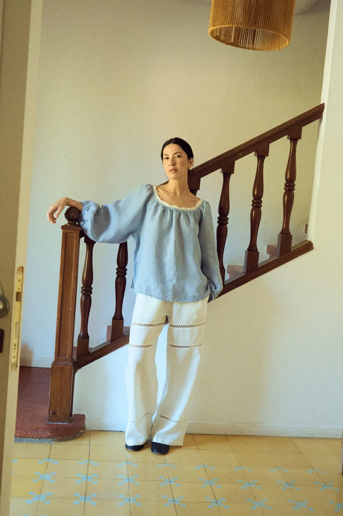White linen trousers with a wide, fluid leg and delicate horizontal lace insets, finished with a soft elastic waistband for an easy, relaxed fit