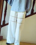 woman is wearing white lace pants in white linen