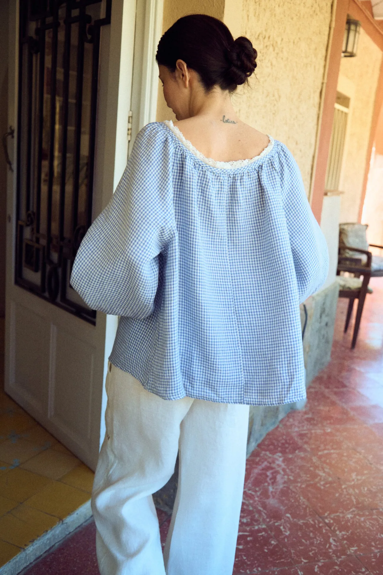 White linen trousers with a relaxed wide-leg silhouette and clean, flowing drape, designed with a soft elastic waistband for all-day comfort