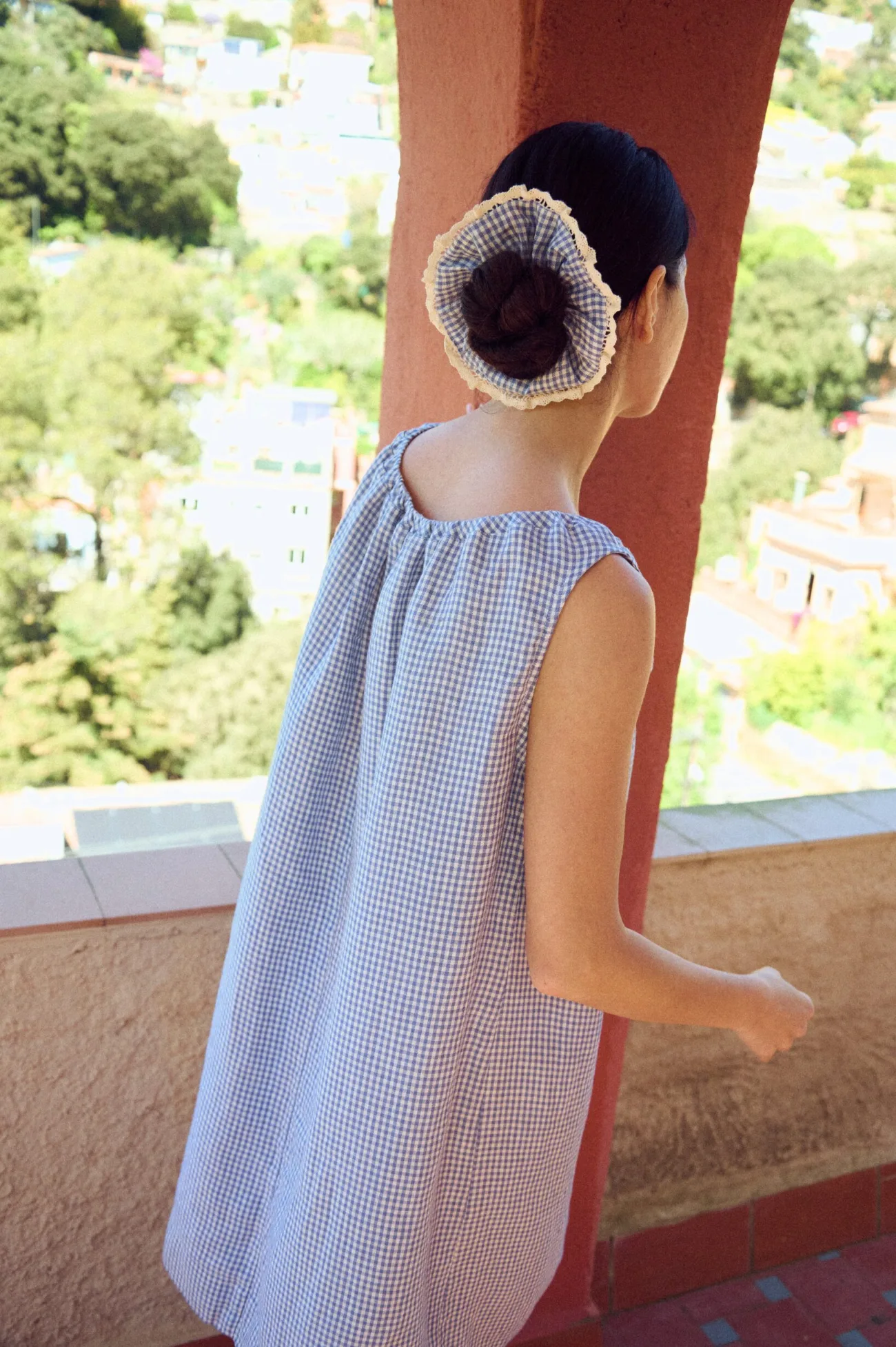the back of blue linen gingham mini dress and matching linen scrunchie