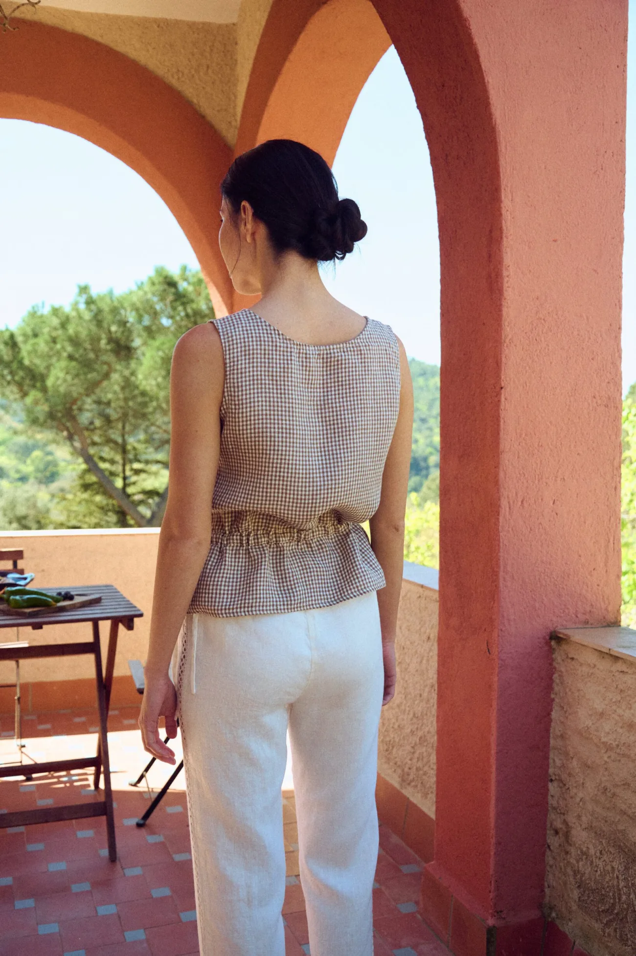 the back of straight cut linen pants with drawstring waist and lace details