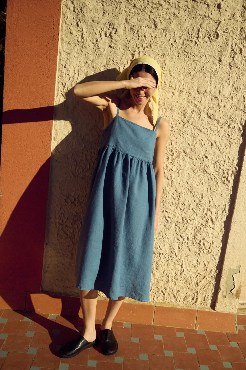 Blue linen midi dress with thin straps and gathered skirt