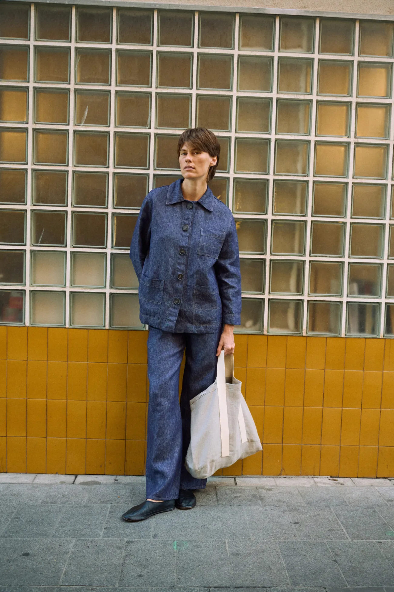 Blue denim linen jacket with patch pockets, matching linen pants, and natural linen tote bag