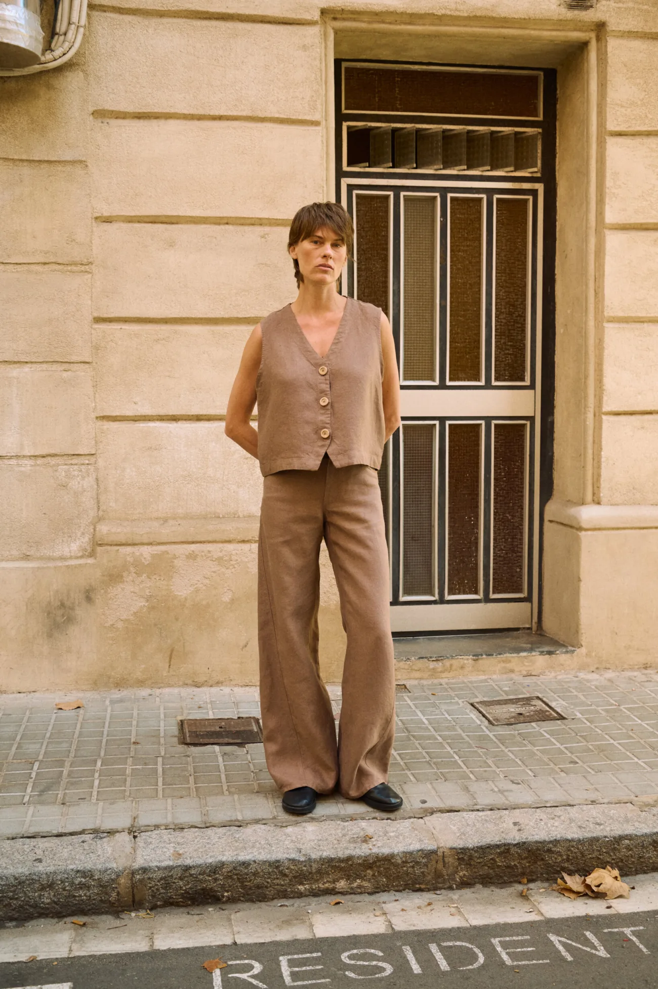 Brown heavy linen wide-leg trousers styled with a matching button-front linen vest