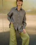 Brown striped linen button-up shirt with a loose draped fit, styled with olive green wide-leg trousers