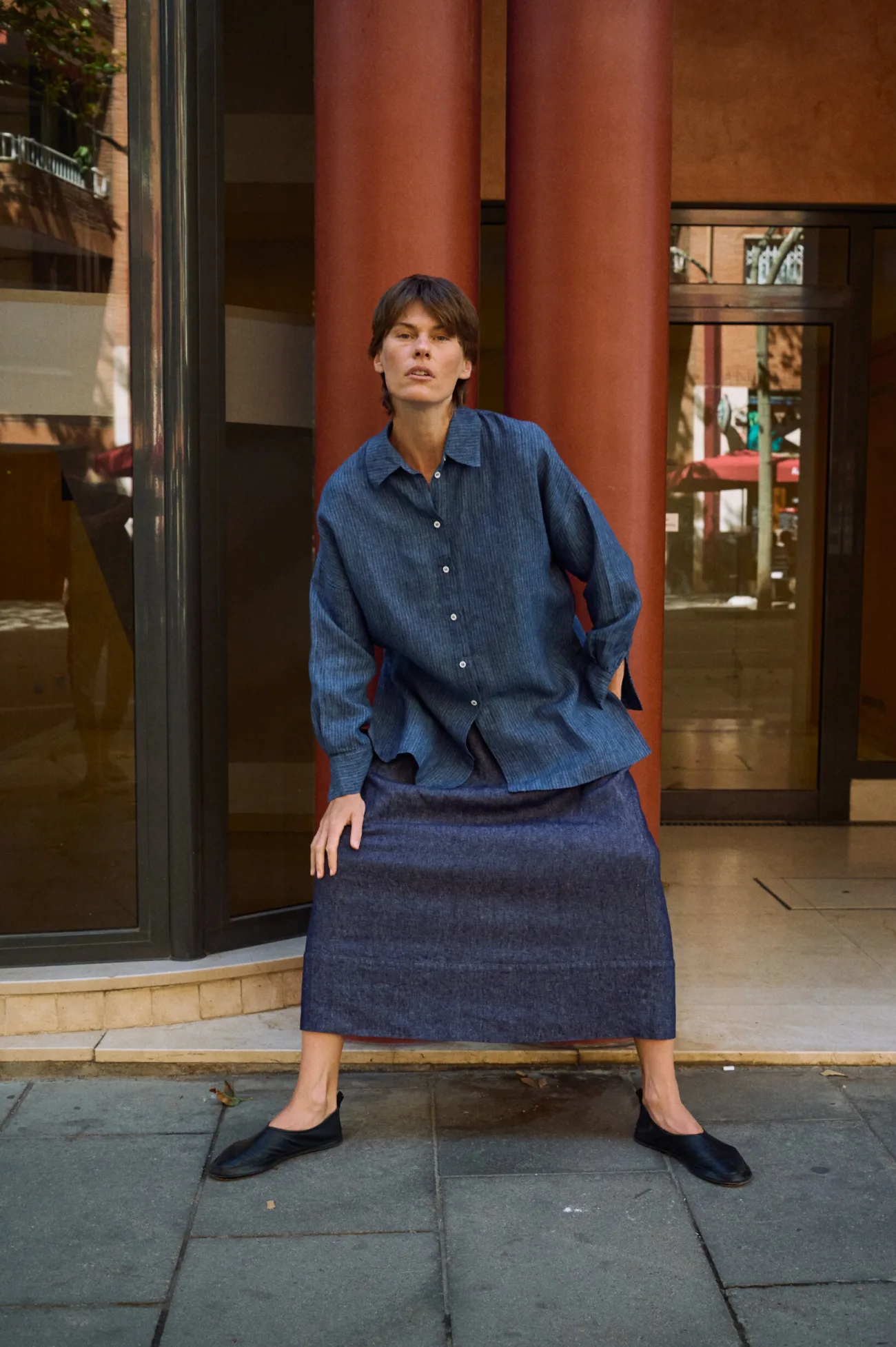Long denim linen skirt styled with a blue striped linen button-up shirt