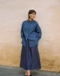 Full-length denim linen maxi skirt with a gently flared shape, paired with an oversized blue striped linen shirt