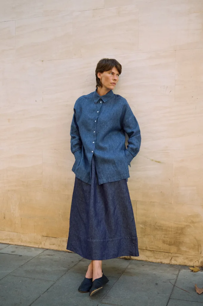 Full-length denim linen maxi skirt with a gently flared shape, paired with an oversized blue striped linen shirt