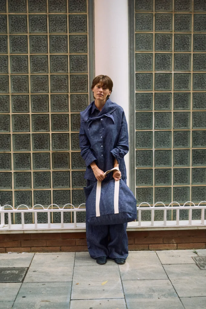 Denim linen large tote bag with wide cream cotton handles, paired with a denim linen shirt, wide-leg trousers and a blue check scarf