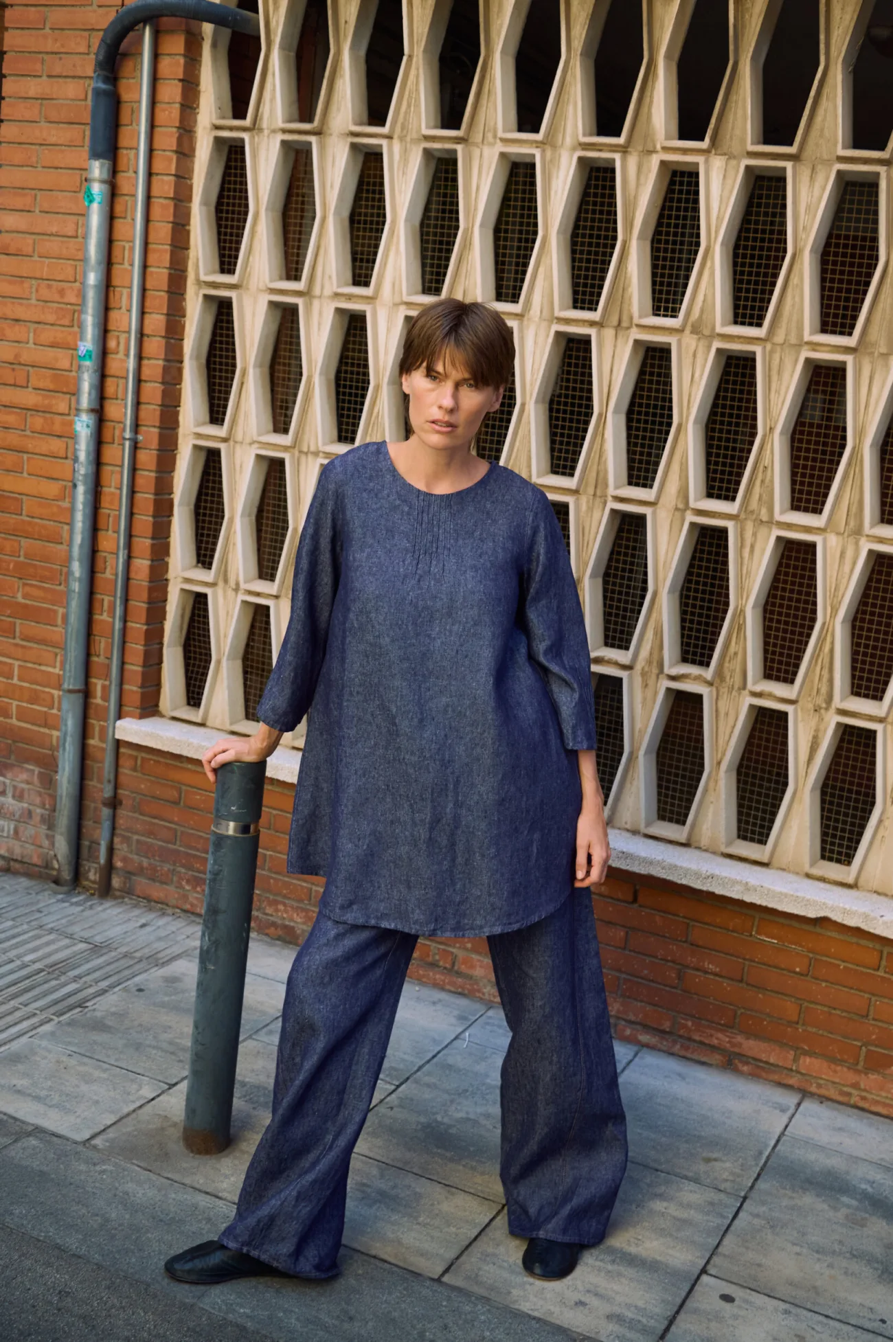 Denim linen tunic dress with a relaxed A-line shape and pintuck neckline detail, styled over matching wide-leg trousers
