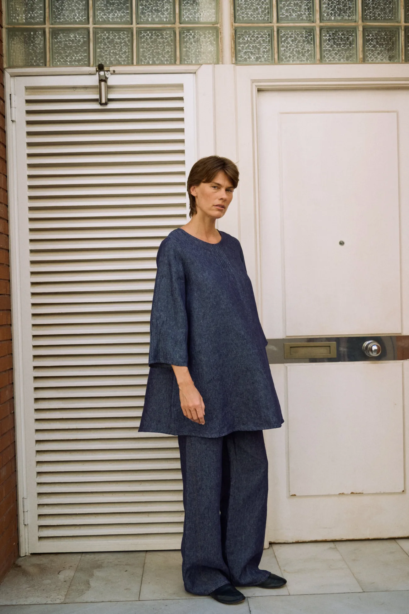 Denim linen midi dress with a relaxed A-line silhouette, styled over matching wide-leg trousers