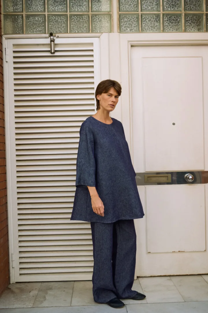 Denim linen midi dress with a relaxed A-line silhouette, styled over matching wide-leg trousers