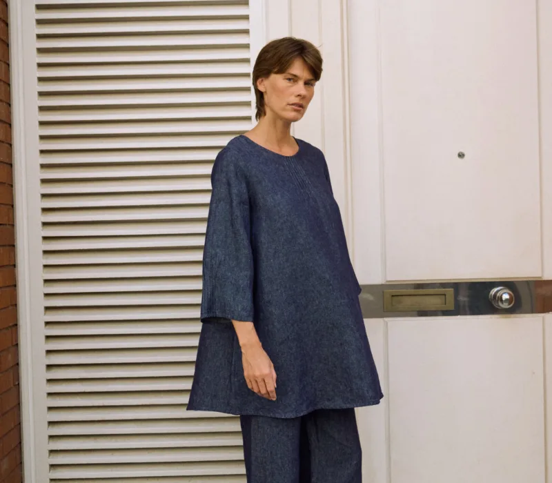 Denim linen midi dress with a relaxed A-line silhouette, styled over matching wide-leg trousers