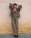 Brown striped linen blouse with an oversized flowing silhouette and voluminous sleeves, paired with matching wide-leg linen trousers